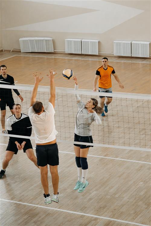 men and women playing volleyball